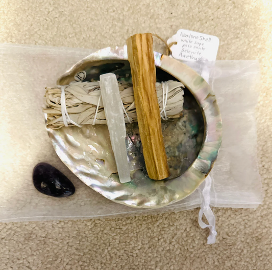 Abalone shell with white sage, Palo Santo stick, selenite and an Amethyst crystal